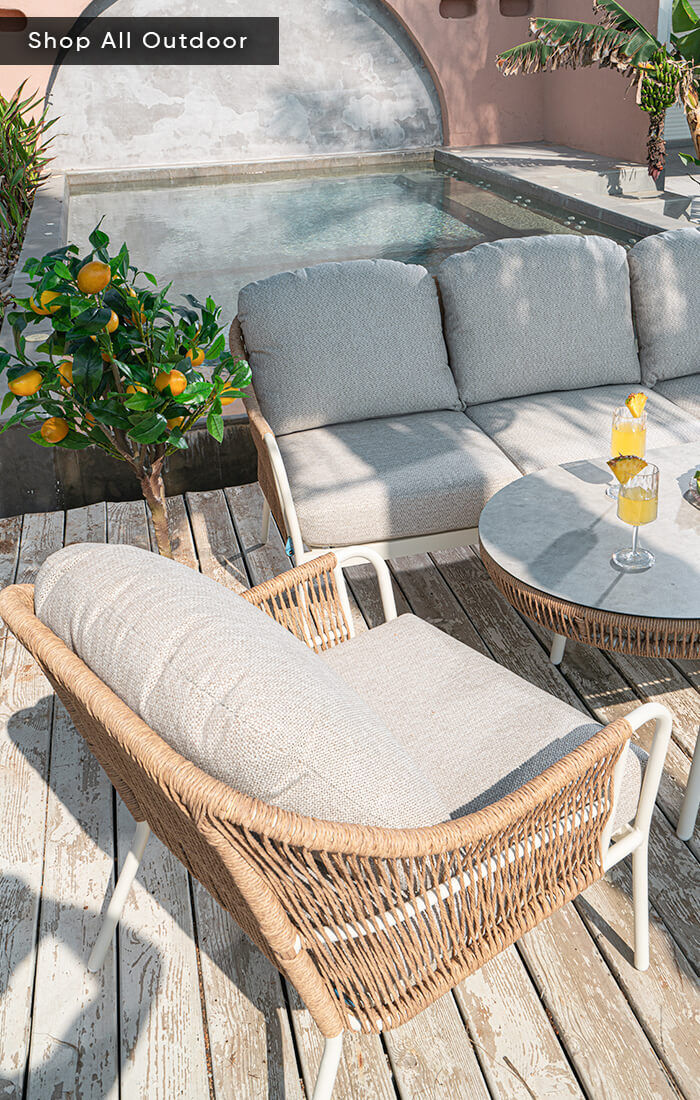 Outdoor furniture set with a chair, a three-seater sofa, and a table in the middle, arranged on a patio for a comfortable outdoor setting.